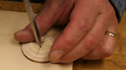hand-held button showing chisel cutting between holes