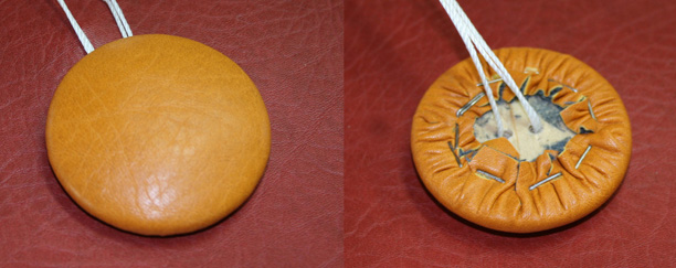 two views of newly covered button - top and bottom (stapled on bottom)