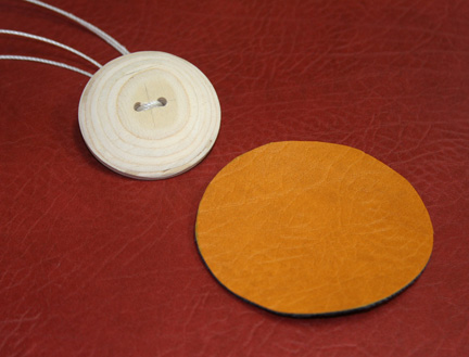button with twine through two holes and cover fabric cut-out