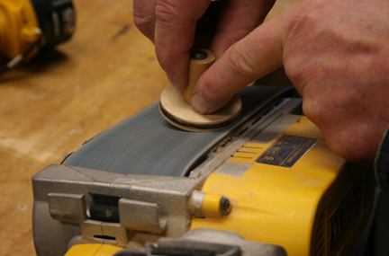 belt sander with hand-held button attached to dowel for easy grasp
