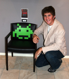 Man with black & green art chair