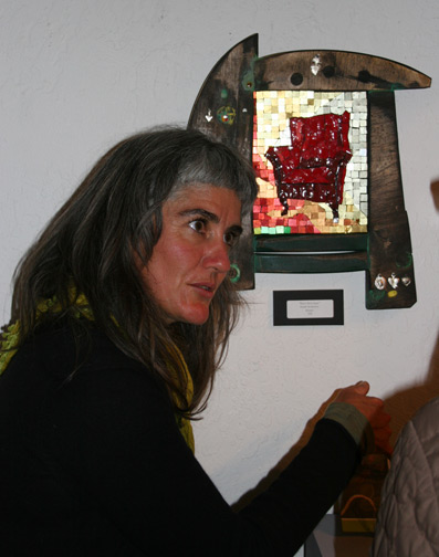 woman talking about her art piece with a gallery visitor