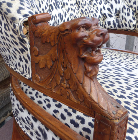 Carved lion head arm chair with leopard upholstery fabric