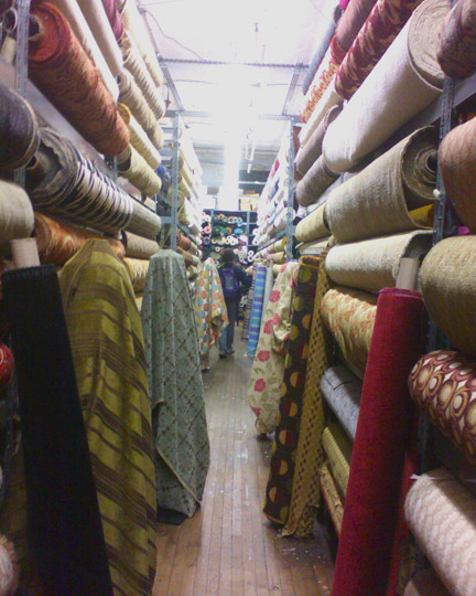 bolts of fabric stacked to the ceiling