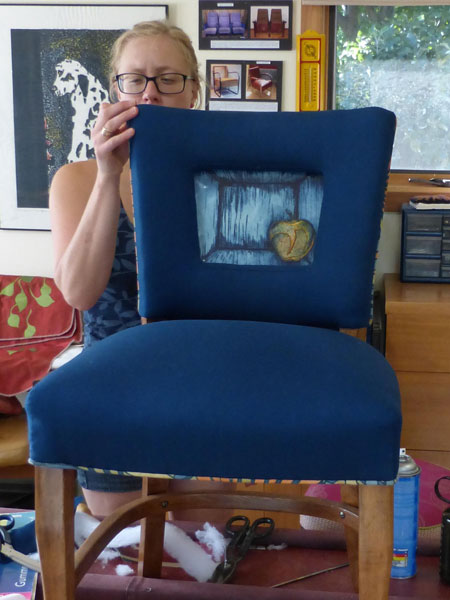 Upholstered window back chair with art print incorporated