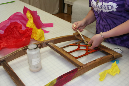 Anastasia works on her tissue-wrapped Jewelry Rack from an upcycled chair back 
