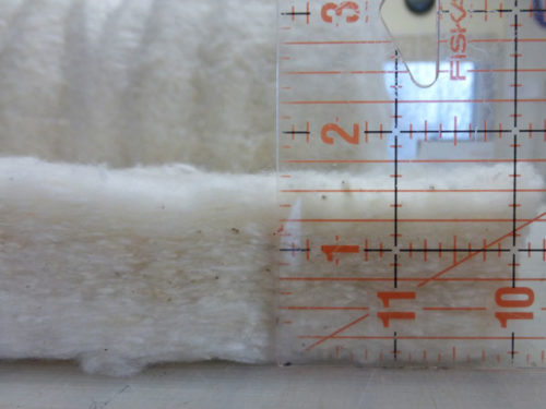 Organic cotton batting with ruler showing 1.5 inch thickness